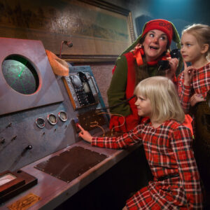 Elf and children in the command center at Santa Claus Secret Forest - Joulukka.