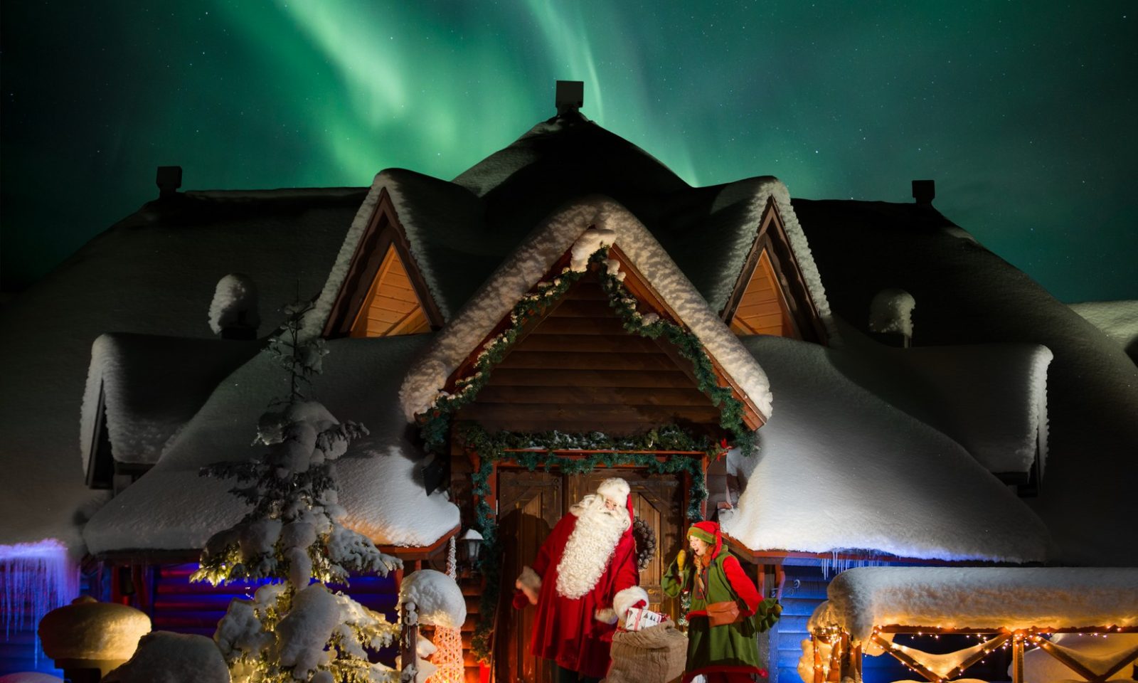 Santa and elf at IsoTokka with Northern Lights
