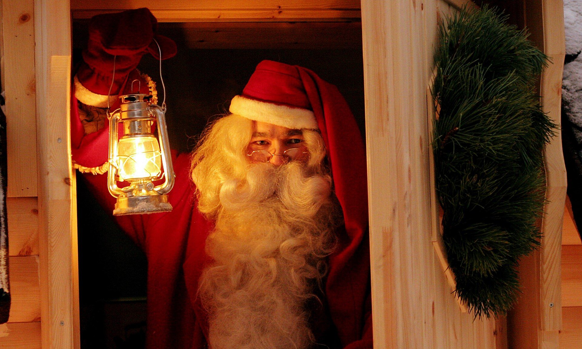 Santa Claus holding a lantern in the Santa Claus Secret Forest Joulukka. | Rovaniemi, Lapland