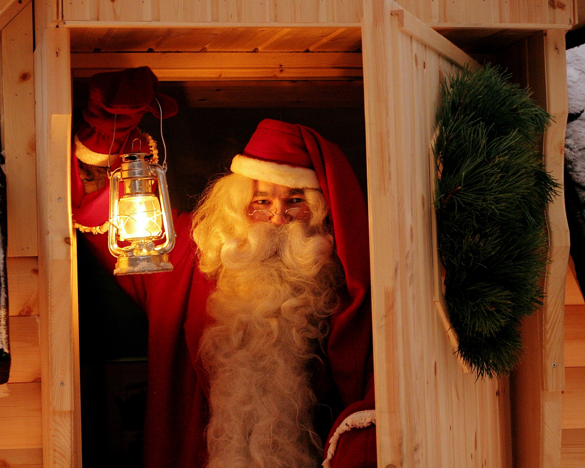 Santa Claus holding a lantern in the Santa Claus Secret Forest Joulukka. | Rovaniemi, Lapland